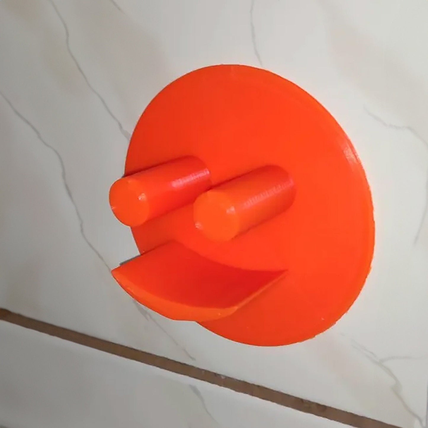 a close up of an orange object on a wall