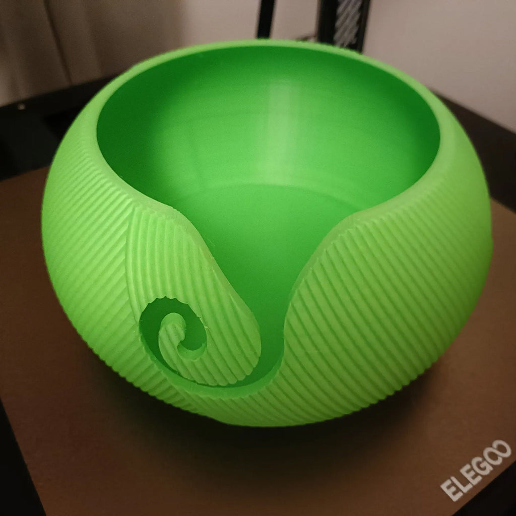 Yarn bowl with swirl cutout for knitting and crochet, holding a ball of yarn, view 4