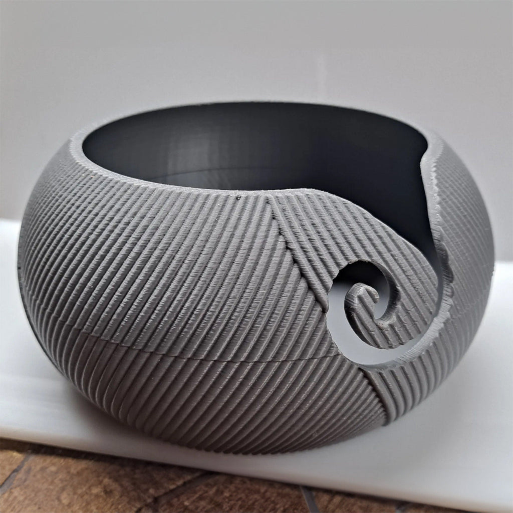 Yarn bowl with swirl cutout for knitting and crochet, holding a ball of yarn, view 5