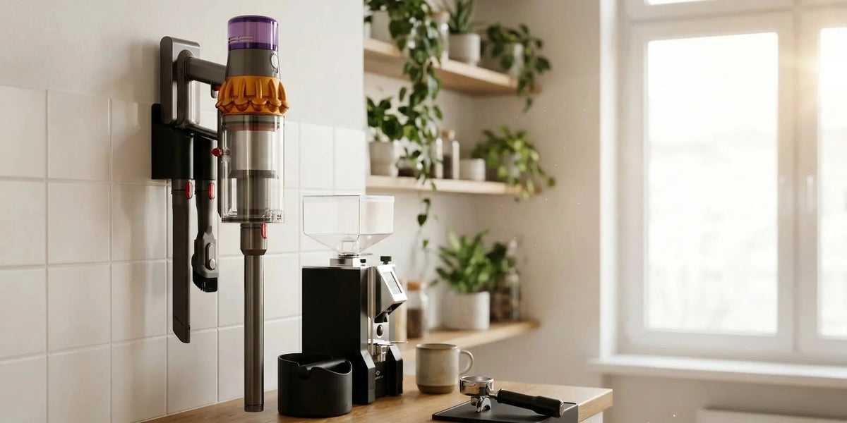 Dyson cordless vacuum on a Plastiwave wall mount in a bright kitchen