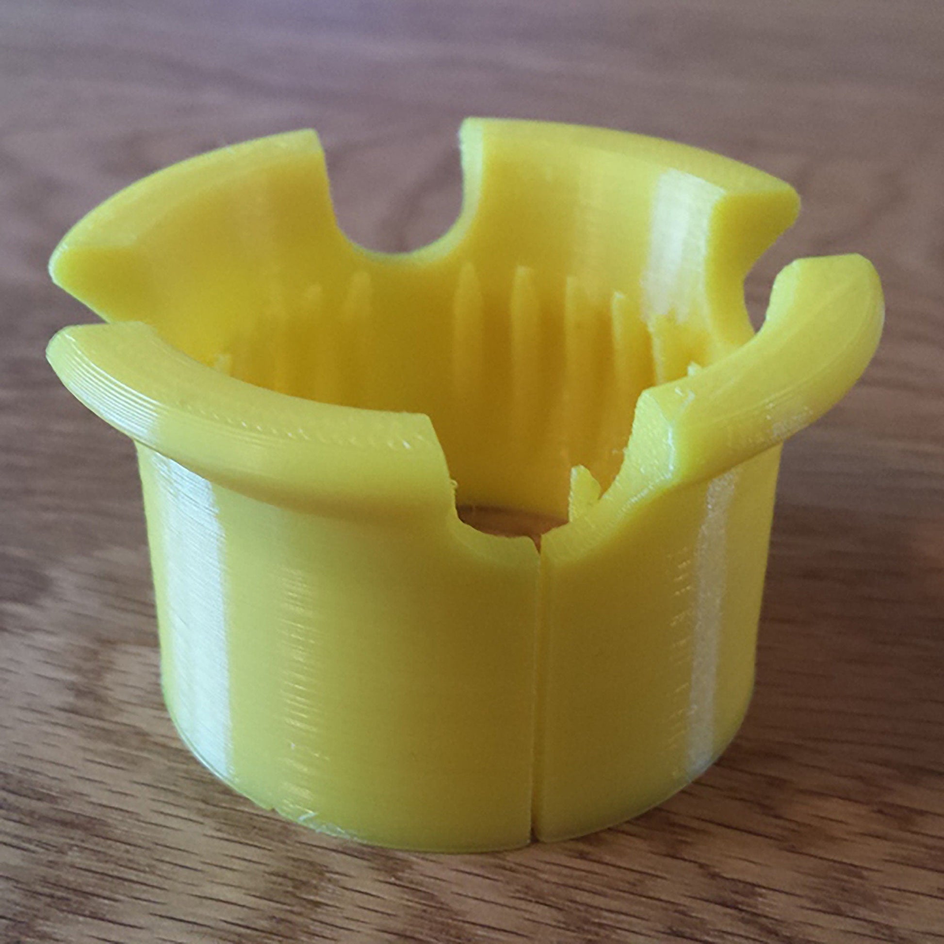 a yellow cup sitting on top of a wooden table