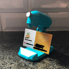 Stand mixer shaped business card holder for bakers holding one card upright